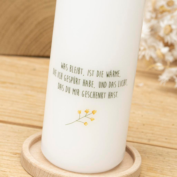 Trauerkerze Sonnenblume mit Spruch auf der Rückseite der Kerze